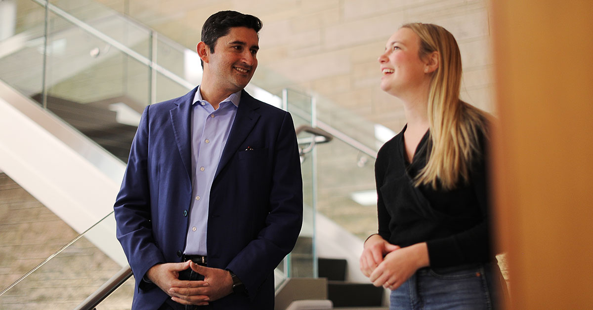 Oz Parvaiz talking to a woman about 20 years experience at Capital One